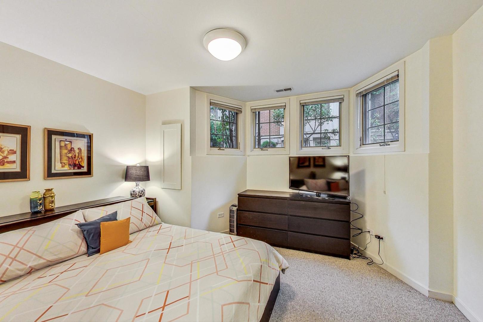 18 North Ada Street, Unit D Chicago, IL 60607 - Photo 39 of 42 a bedroom with a bed and furniture