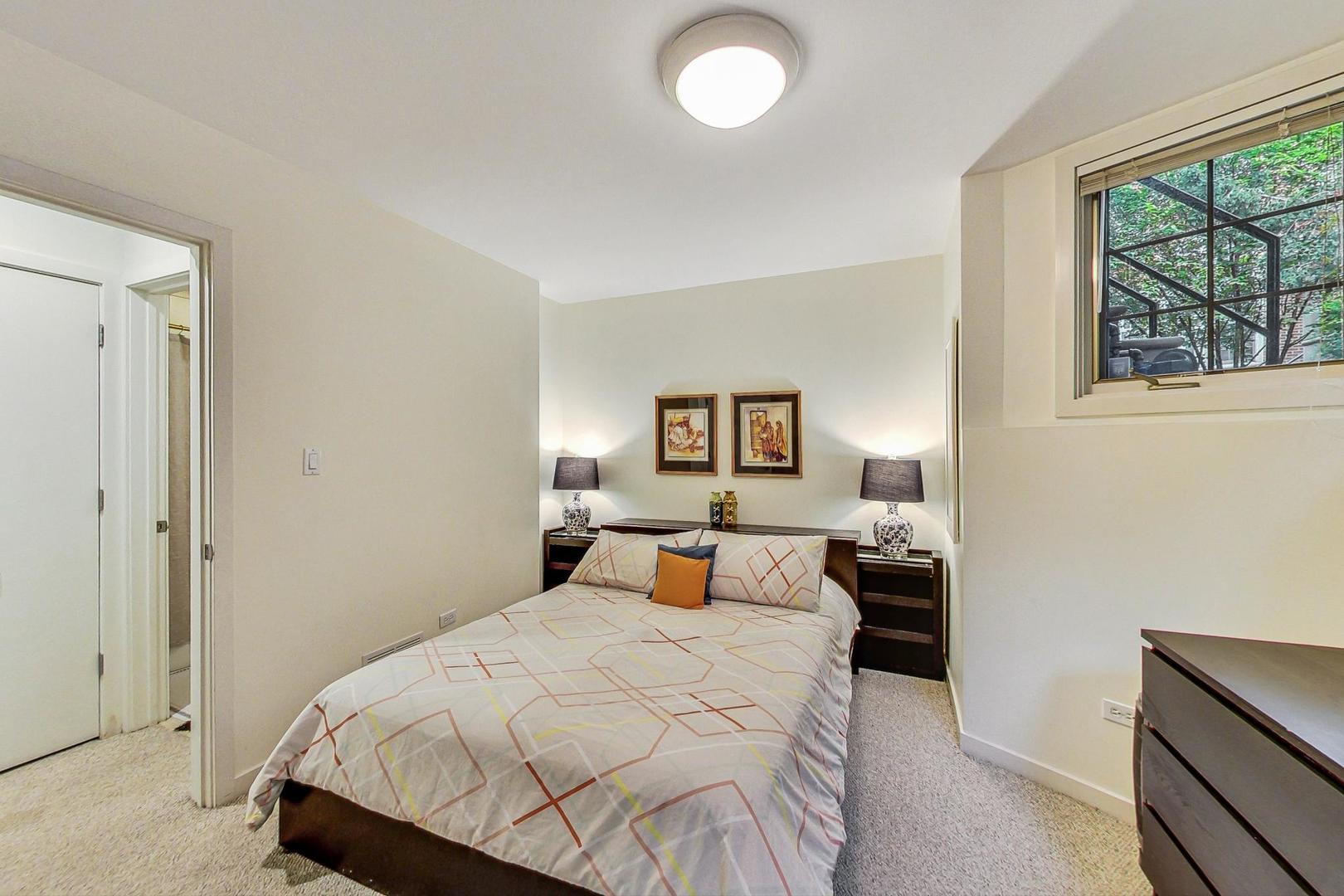 18 North Ada Street, Unit D Chicago, IL 60607 - Photo 40 of 42 a bedroom with a bed and window