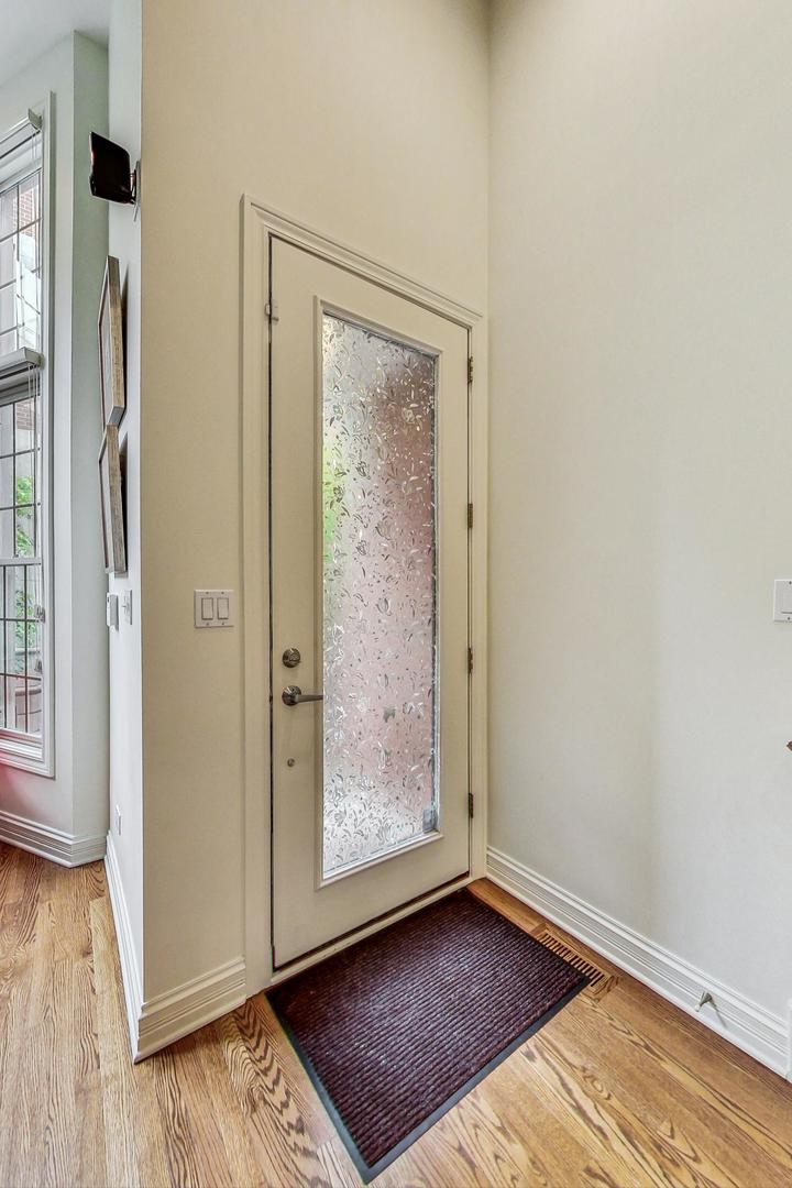 18 North Ada Street, Unit D Chicago, IL 60607 - Photo 10 of 42 an empty room with wooden floor and windows