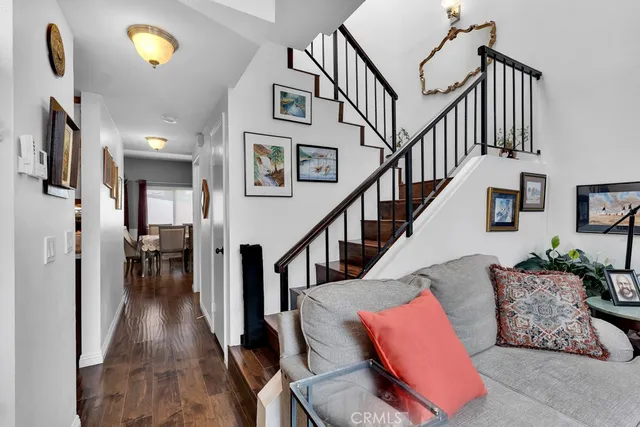 a view of livingroom with furniture entryway and wooden floor