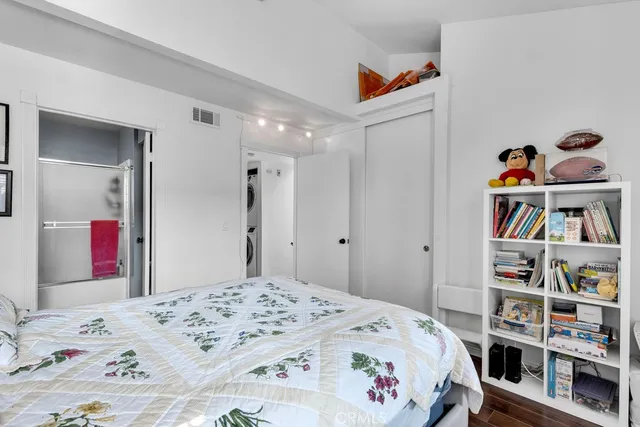 a bedroom that has a bed and a book shelf