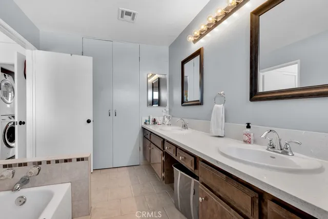 a bathroom with a double vanity sink mirror and