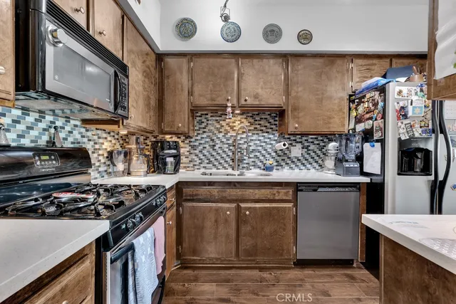 a kitchen with stainless steel appliances granite countertop a stove and a microwave