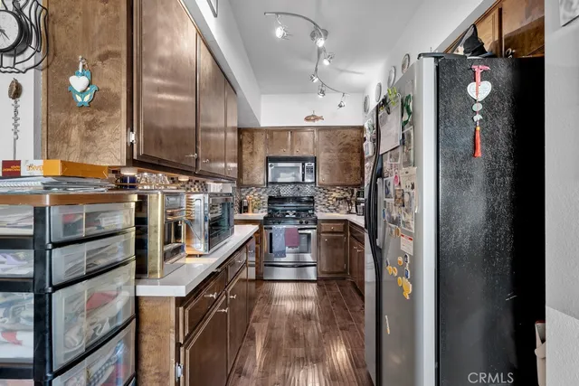 a kitchen with stainless steel appliances granite countertop a refrigerator and a stove
