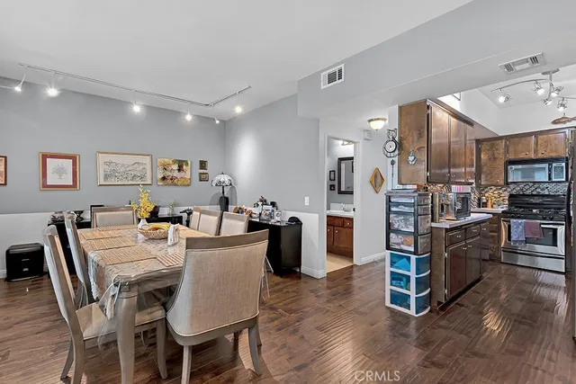 a large kitchen with a table and chairs