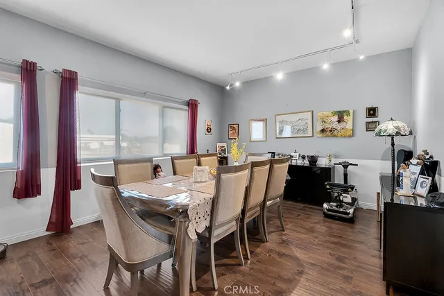 a view of a dining room with furniture and a window