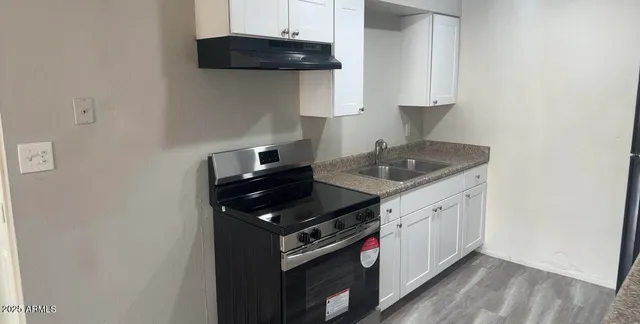 a kitchen with a refrigerator and cabinets