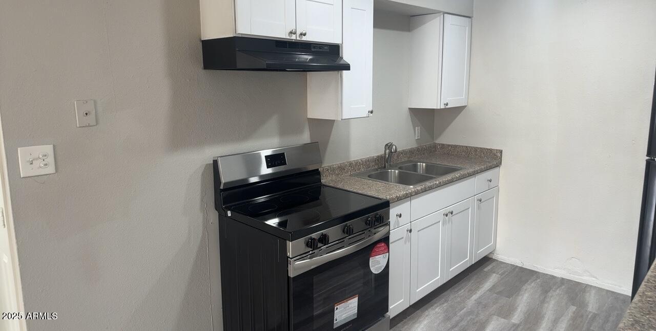 2034 West Cactus Road, Unit C Phoenix, AZ 85029 - Photo 2 of 10 a kitchen with stainless steel appliances granite countertop a stove a sink and a microwave
