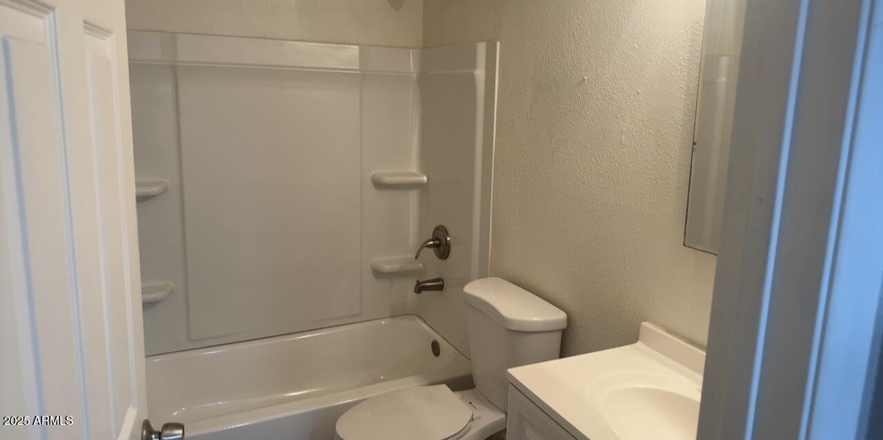 2034 West Cactus Road, Unit C Phoenix, AZ 85029 - Photo 7 of 10 a white toilet sitting next to a bath tub
