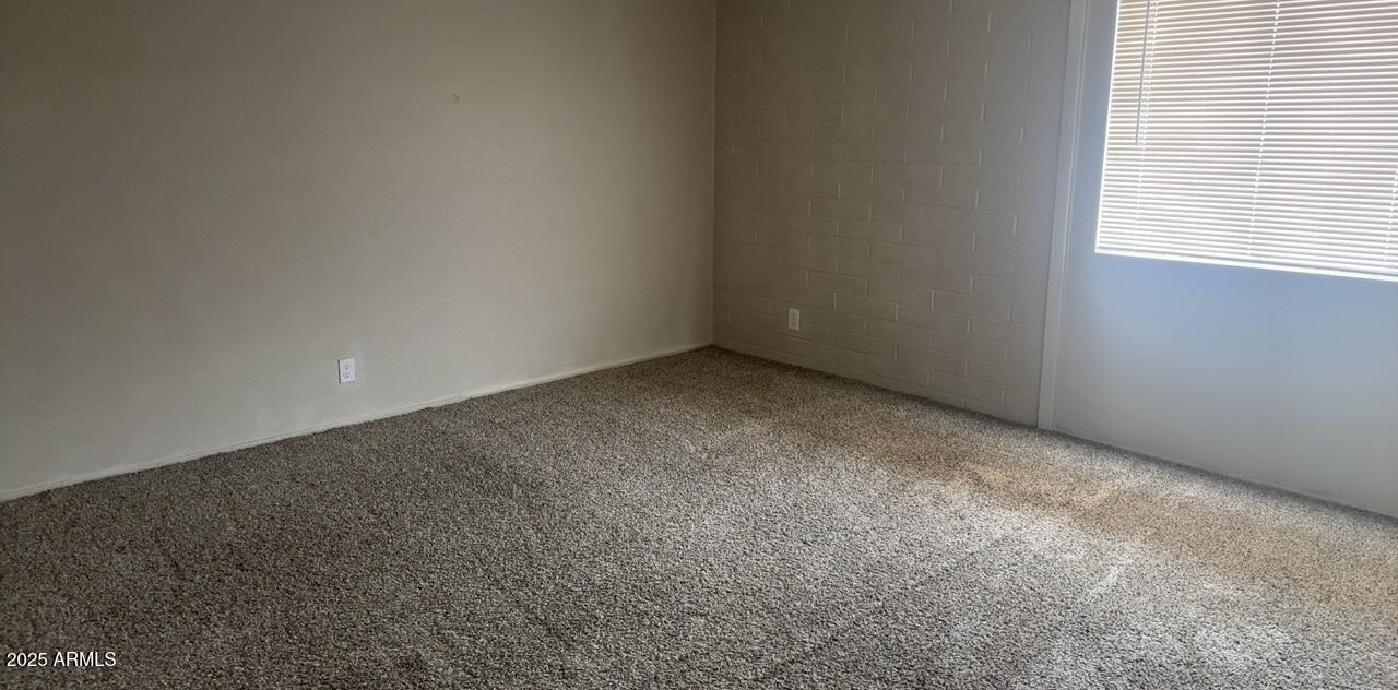 2034 West Cactus Road, Unit C Phoenix, AZ 85029 - Photo 9 of 10 an empty room with a empty space and window