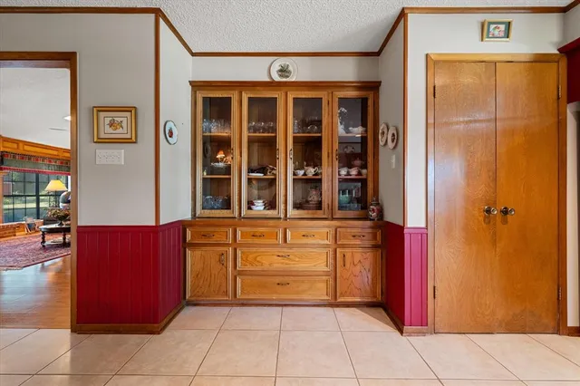 a view of kitchen with stainless steel appliances granite countertop a refrigerator and a stove