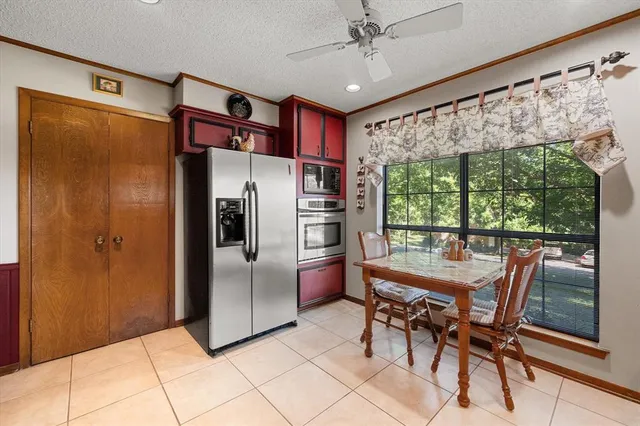 a kitchen with stainless steel appliances granite countertop a refrigerator and a table