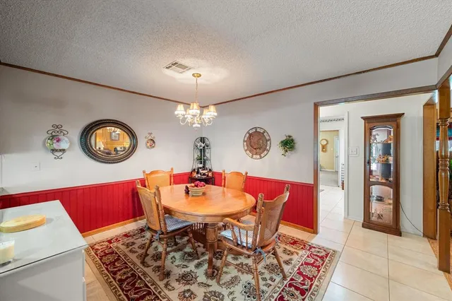 a view of a dining room with furniture and a chandelier