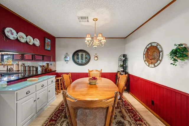 a view of a dining room with furniture and a mirror
