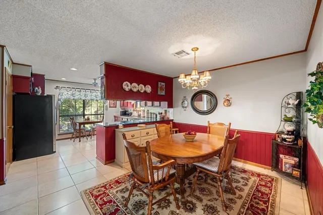 a view of a dining room with furniture and chandelier