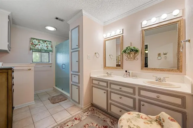 a spacious bathroom with a double vanity sink and a mirror