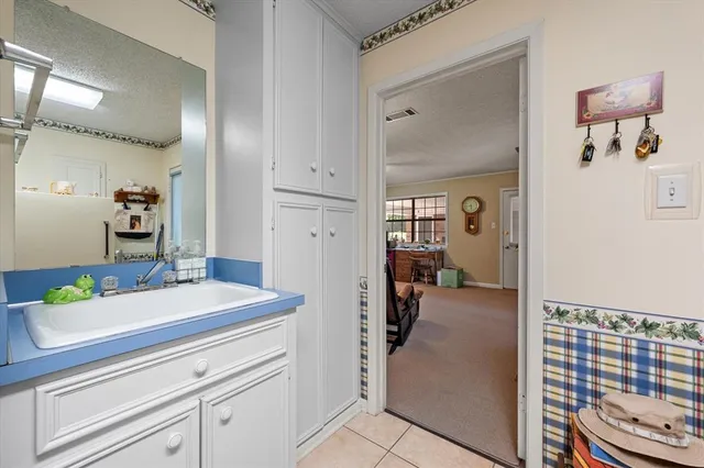 a en suite bathroom with a granite countertop sink and a mirror