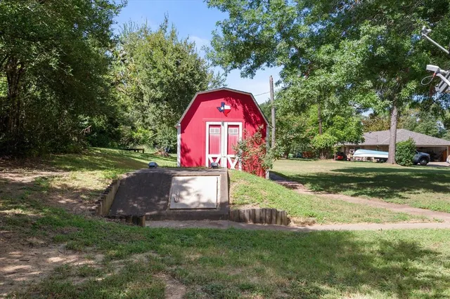 a view of garden with trees in the background