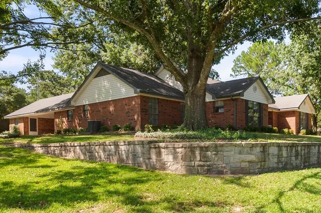 a front view of house with yard and green space