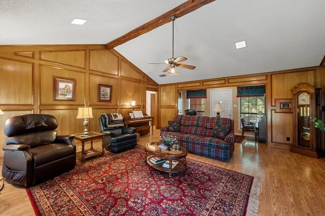 a living room with furniture rug and wooden floor