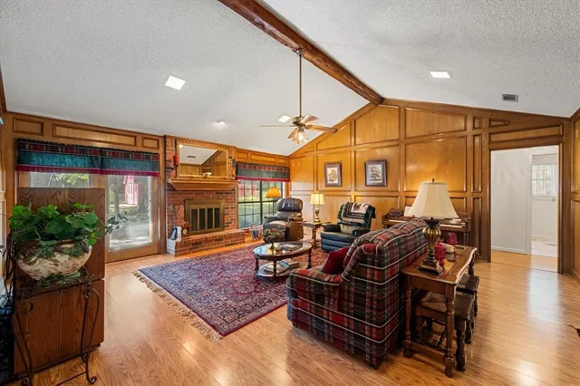 a living room with furniture a fireplace and a potted plant