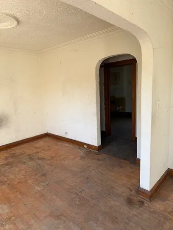 a view of a hallway view with wooden floor and a bathroom
