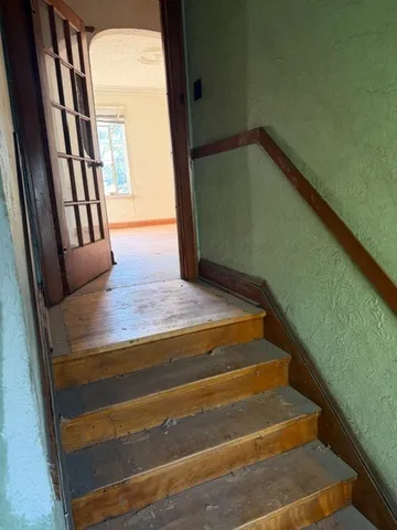 an empty room with windows and closet