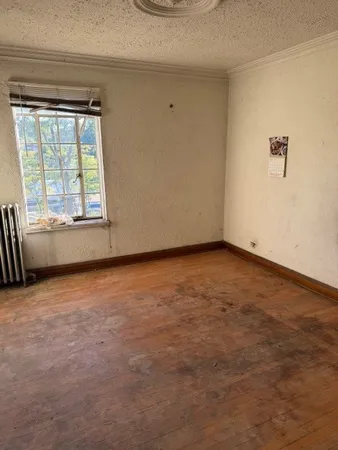 an empty room with windows and closet