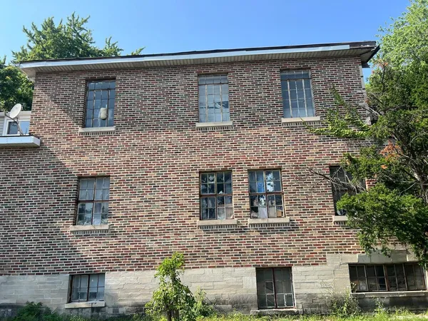 front view of a brick house with a small yard