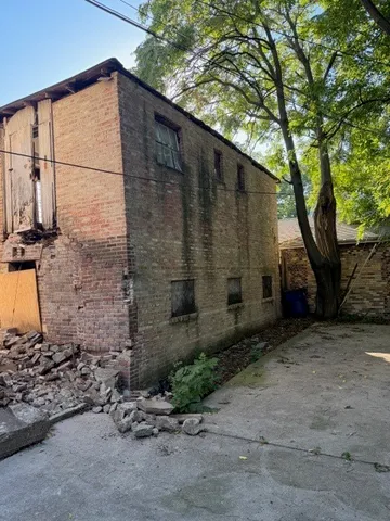 a backyard of a house with a tree