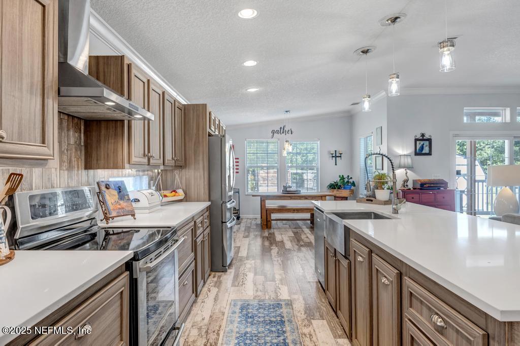 1417 Marlee Road St. Johns, FL 32259 - Photo 17 of 70 a kitchen with counter top space a sink a stove and wooden cabinets