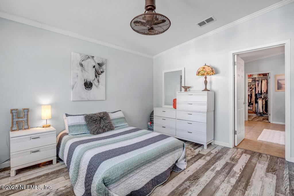 1417 Marlee Road St. Johns, FL 32259 - Photo 32 of 70 a bedroom with a bed and a chandelier