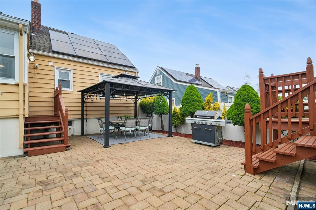 26 Rutgers Place Bloomfield, NJ 07003 - Photo 35 of 38 a view of a patio with a table and chairs under an umbrella