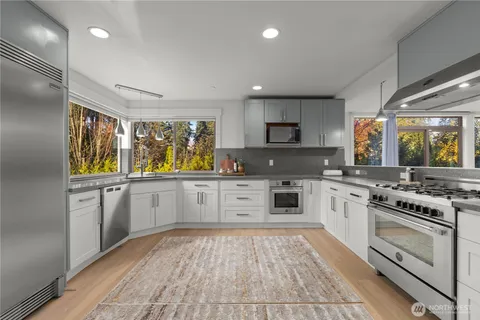a kitchen with stainless steel appliances granite countertop a stove and a sink