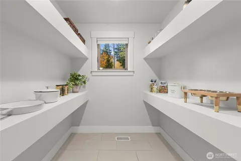 a hallway with a sink and cabinets