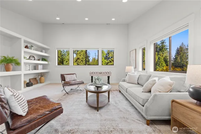 a living room with furniture and a book shelf