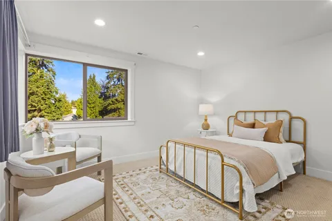 a bedroom with a bed and a painting on the wall