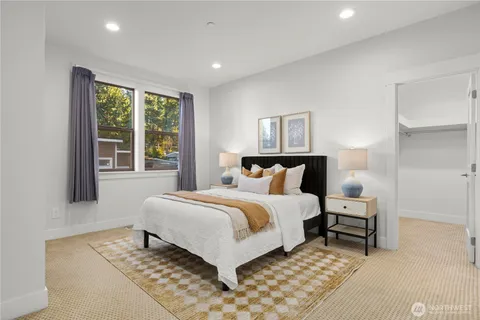 a bedroom with a large bed and a window