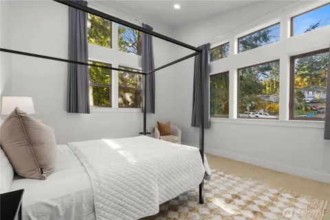 a bedroom with a large window and a bed