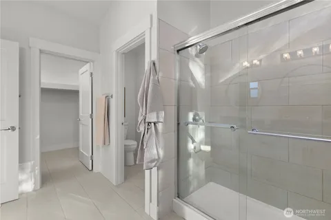a bathroom with a shower and a glass door