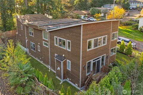 an aerial view of residential houses with yard