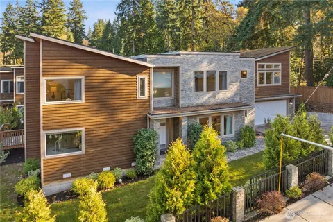 a view of a house with brick walls and flower plants