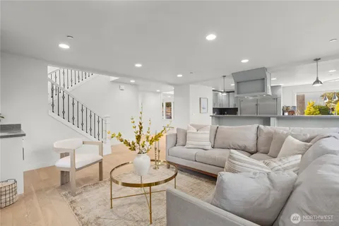 a living room with furniture and kitchen view