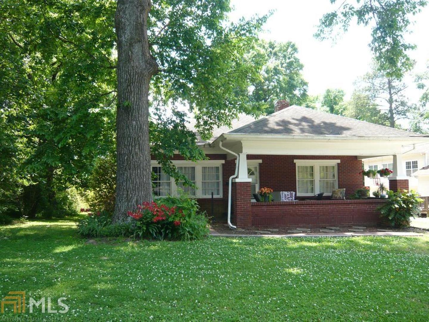 a front view of house with a garden