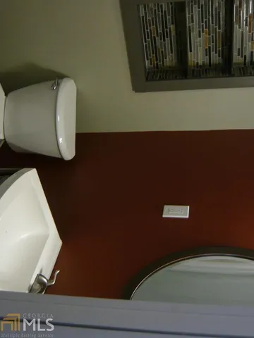 a bathroom with a mirror and a shower