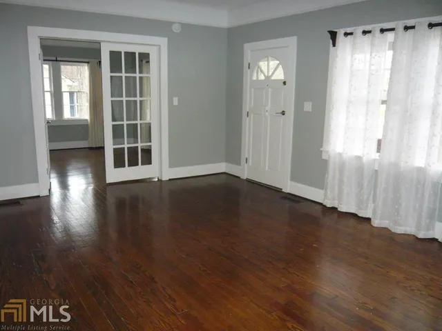 a view of wooden floor and windows in a room