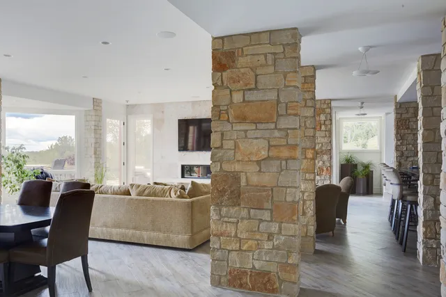 a view of a grassy field with trees in the background