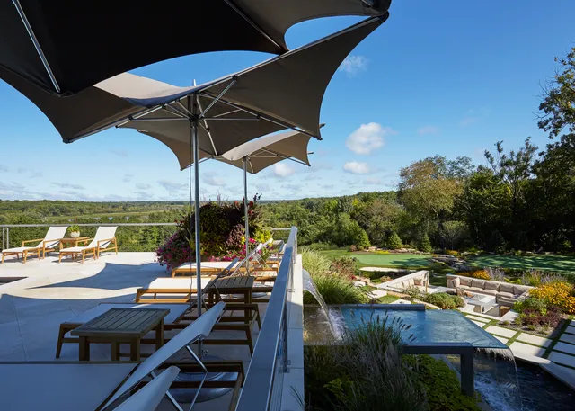 a swimming pool with outdoor seating and yard