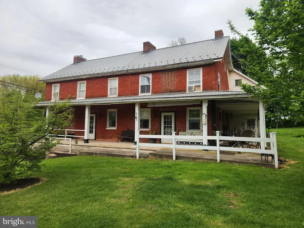 a front view of a house with a garden and porch