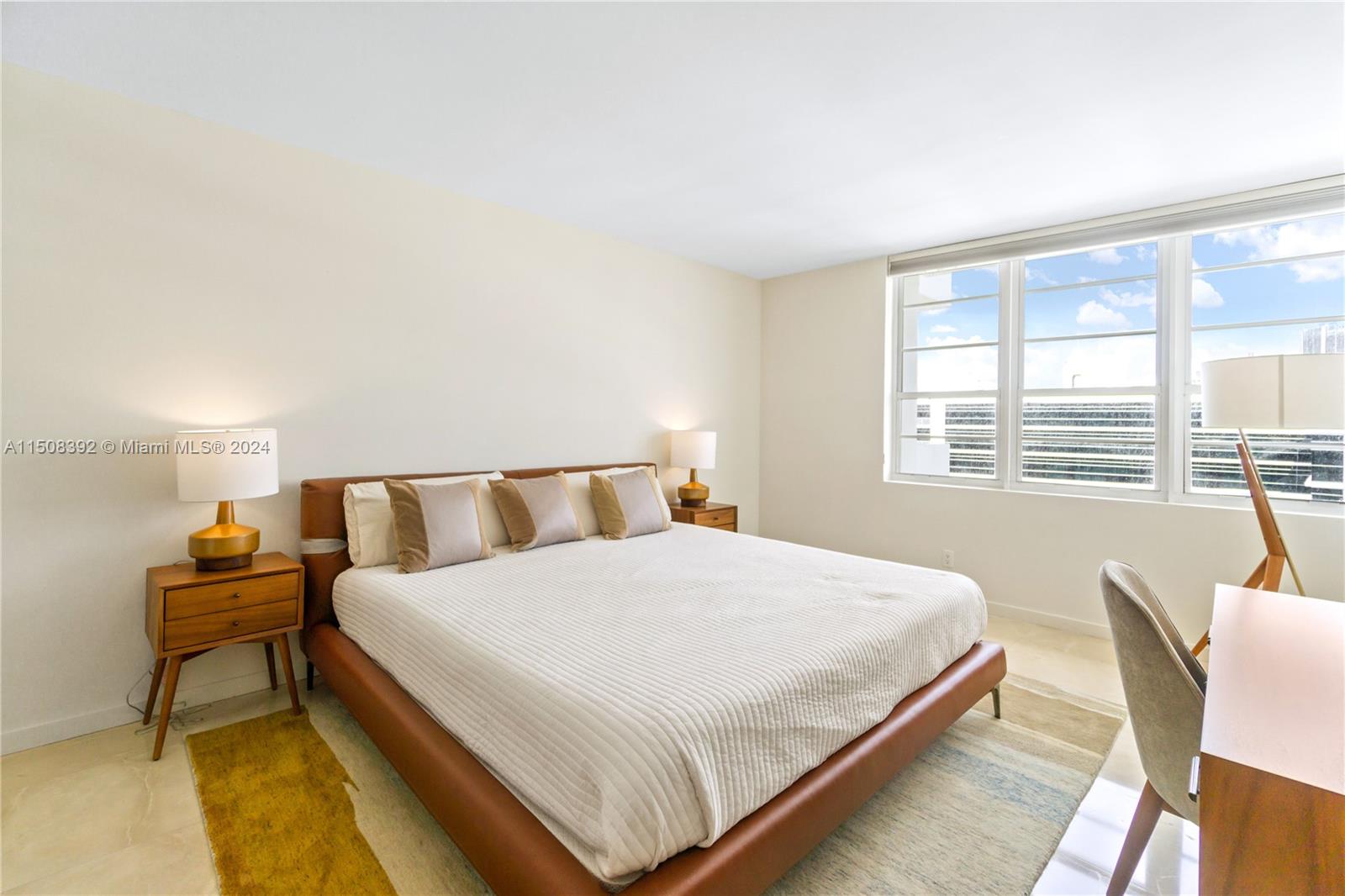100 Lincoln Road, Unit 1202 Miami Beach, FL 33139 - Photo 11 of 23 a bedroom with a bed and a large window